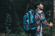 © Charnchai saeheng - Hikers use trekking pole with backpacks and hold tent bag walking through the forest. hiking and adventure concept.