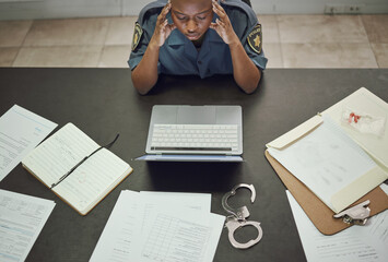 Poster - Police, woman and working with stress at desk with documents, paperwork or frustrated with headache from working on computer case, report. Security, officer and tired from work in office or station