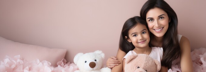 Wall Mural - Portrait of a Indian girl and mother on pink rose gold background. World Mother's Day concept