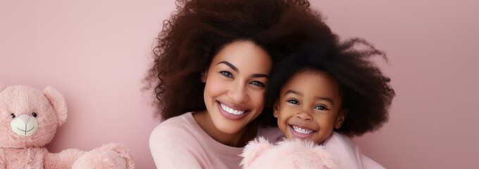 Wall Mural - Portrait of a African American girl and mother on pink rose gold background. World Mother's Day concept