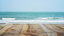Wooden Table Top On Blurred Sea, Waves And Sky. Empty Wooden Table With Summer Sea Waves On Background.  Wooden Table And Sea , Use For Backgroud With Space. 