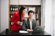 © laddawan - Asian business colleague business presents and explains and using laptop and tablet. Teamwork, financial marketing team,   while sitting in modern office