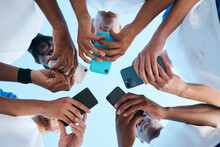 Hands, Phone And App With People In A Huddle Or Circle For Communication Or Connectivity. Mobile, Social Media Or Information Sharing With A Group Of Men Networking Together Closeup From Below
