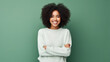 © Sasint - Portrait of a smiling young african woman wearing sweater standing isolated over green background