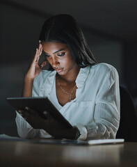 Wall Mural - This feels like a dead end. Shot of a young businesswoman looking stressed out while using a digital tablet in an office at night.