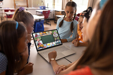 Poster - Asian female teacher and diverse students having a video conference on laptop at school