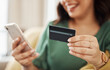 Phone, credit card closeup and woman hands with online shopping and banking at home. Ecommerce, mobile cashback and sale with digital payment and easy pay with discount and smile from web checkout
