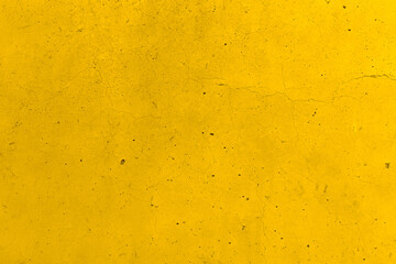 Dirty old cracked yellow concrete wall texture background.  Grunge and rough texture.  Vintage style of the wall. 