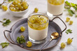 Jelly with gooseberries and vanilla panna cotta. Layered summer dessert in glass.