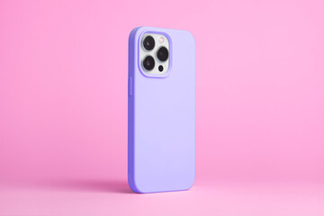 Wall Mural - smart phone in purple case back side view isolated on pink background, iPhone 15 Pro case mock up