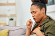 © Bettencourt/peopleimages.com - Sick, cough and woman in home with health problem of flu, cold or medical virus. Black female person, pain and coughing for asthma attack, tuberculosis and sore throat of allergy, lungs or pneumonia