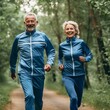 © Valua Vitaly - Happy senior couple jogging in the forest in matching sports costumes. Cheerful middle aged partners on a walk in the woods. Beautiful elderly couple outdoors on a chilly spring day.