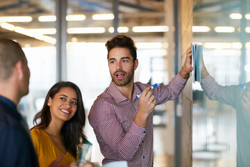 Poster - Hes on top of things. Cropped shot of three businesspeople working in the office.