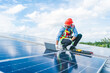 © chokniti - Male professional engineer installing solar photovoltaic panel system, Electrician mounting blue solar module technology on power industrial factory roof, Alternative energy ecological technician job