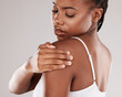 Black woman, shoulder pain and injury with health risk, muscle tension and stress on a grey studio background. Female person, inflammation or model with joint strain, sore and swollen with body ache
