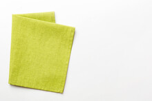 Top View With Green Kitchen Napkin Isolated On Table Background. Folded Cloth For Mockup With Copy Space, Flat Lay. Minimal Style