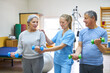 © Robert Kneschke - Nurse assisting senior people exercising with dumbbells