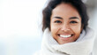 © wetzkaz - young adult woman, multiethnic multiracial or hispanic, portrait, face, white teeth smiling, tanned skin, dark medium length hair, front view, wearing white winter scarf, glaring vibrant glowing