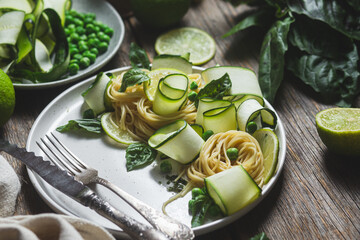 Wall Mural - Pasta with zucchini and green peas in a bowl