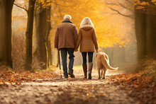 Senior Couple With A Dog Walks On Autumn Park. AI Generated