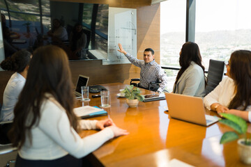 Wall Mural - Disabled businessman giving presentation to colleagues in a meeting room