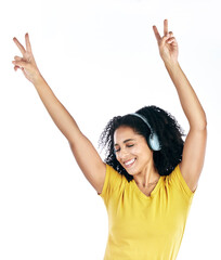 Wall Mural - Music, dancing and a woman with headphones and peace sign in studio streaming audio, sound or radio. Energy, happy and a young person isolated on a white background listening to fun song to relax