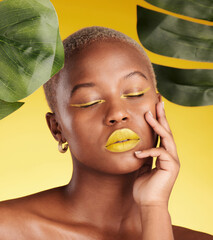 Wall Mural - Calm black woman, makeup and natural beauty in relax for cosmetics with leafs against a yellow studio background. Face of African female person with eyes closed in satisfaction for facial treatment