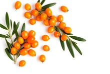 A Group Of Orange Berries With Green Leaves