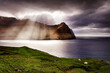 Dramatic sunlight in the clouds, view from Vidoy island at Bordoy island in Faroe islands, Northern Europe
