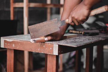 Carpenter working with equipment on wooden table, And measurement of a wooden plank