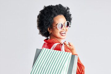 Happy black woman, afro and shopping bags for discount, sale or fashion deal against a white studio background. Portrait of African female person, customer or shopper smile for purchase in happiness