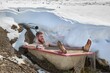 Taking cold plunge inmersing in a snowy bathtub