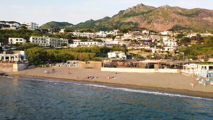 Canvas Print - Overhead aerial view of Ischia Citara Beach at sunset with pools and sand