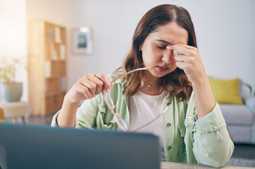 Headache, stress and woman on laptop in home with deadline for project, report and online task. Remote work, overworked and female person with burnout, frustrated and worry for freelance business