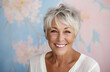 © OPPERMAN - Senior woman with short hair posing against a floral print wall.