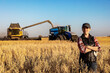 © Designpics - Portrait of a mature farm woman standing in a grain field during harvest at sunset, Alberta, Canada
