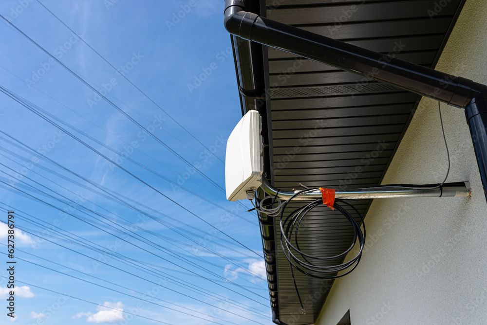 Antenna amplifier for mobile internet at home, mounted on the facade of the house outside.