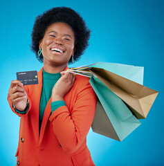 Sticker - Woman, credit card and shopping bag for retail banking, finance and e commerce fintech or payment in portrait. Happy customer, fashion model or african person offer or debit on blue studio background