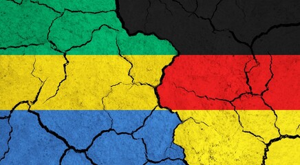 Flags of Gabon and Germany on cracked surface - politics, relationship concept