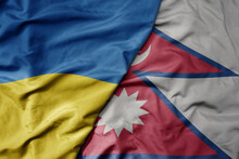 Big Waving National Colorful Flag Of Ukraine And National Flag Of Nepal .