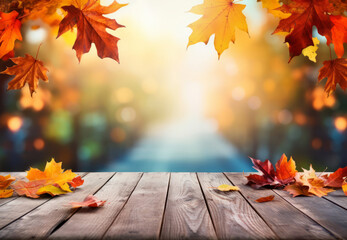 Wall Mural - Empty wooden table with fall leaves, glowing sun and blurry seasonal colors. Autumn copy space background.