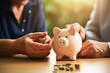 Senior mature retired couple counting pension savings. Piggy bank, money and finances concept, investment for a future, pension fond. High quality photo