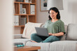 © Daniels C/peopleimages.com - Happy woman, remote work and laptop on sofa in home for digital planning, online research or blog info. Female freelancer working on computer, technology and website media for telework in living room