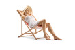 © Ljupco Smokovski - Beautiful young woman in a white dress and straw hat enjoying on a beach chair