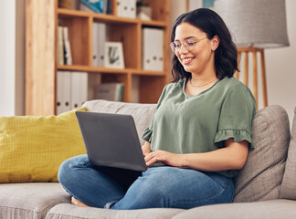Sofa, laptop and woman or student in e learning, online education and typing for university or work from home research. Computer, information or knowledge of young person on couch and college website