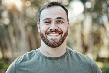 Portrait, smile and a man in nature during summer for travel, freedom or adventure in the wilderness. Face, happy and a male hiking in the forest or woods for adventure, holiday or vacation outdoor