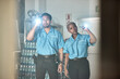 © Malik/peopleimages.com - Flashlight, police and man and woman for investigation, inspection and property search at night. Surveillance team, law and security people in dark room for safety, crime and protection service