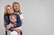 © New Africa - Three generations. Happy grandmother, her daughter and granddaughter on light gray background, space for text