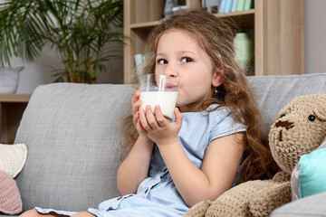 Poster - Cute little girl drinking milk at home