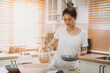 © Sevendeman - Asian woman enjoy cooking simple noodle in the kitchen as a hobby.